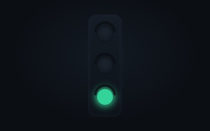 A matte black stoplight with the green light lit